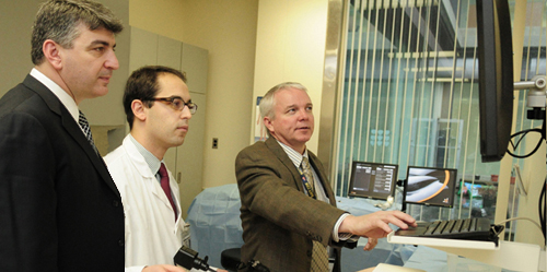 Dr. Michael Polcino, a fourth-year resident, at the controls of a simulated laparoscopic procedure, with Drs. Apostolos Tassiopoulos and Richard Scriven. Dr. Michael Polcino, a fourth-year resident, in Sim Center
