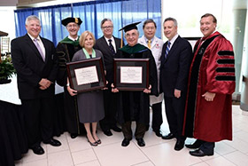 Photograph of President Stanley, L. Reuven Pasternak, Kenneth Kaushansky, Basil Rigas, Vincent W. Yang, with William and Jane Knapp