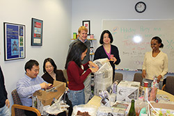Photograph of everyone exchanging gifts within the lab